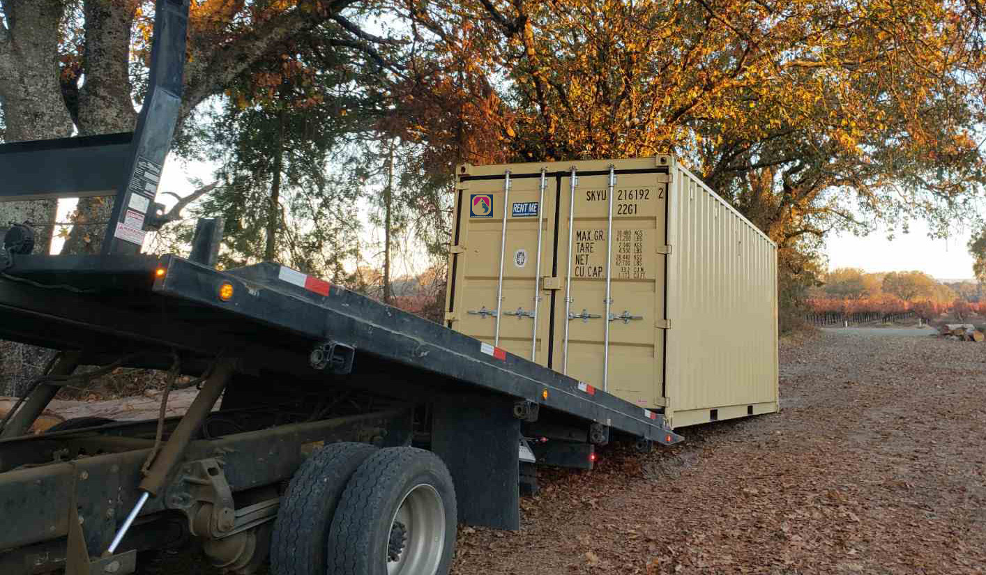 Shipping container being delivered to a property